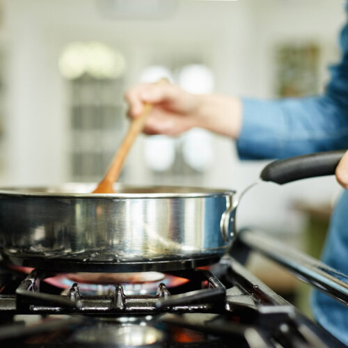 woman cooking on gas stove